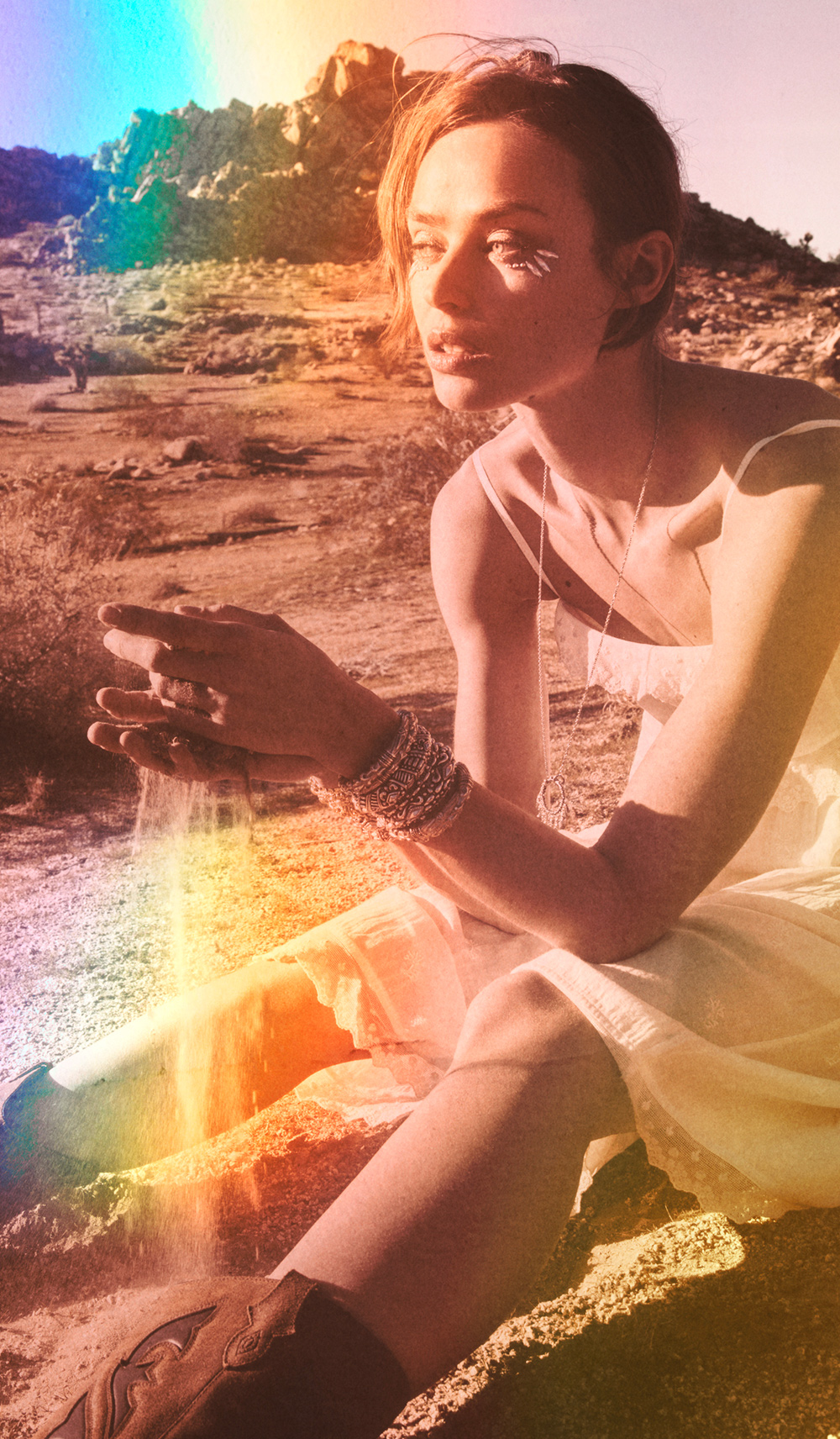 a model sitting on the floor wearing a dress and boots