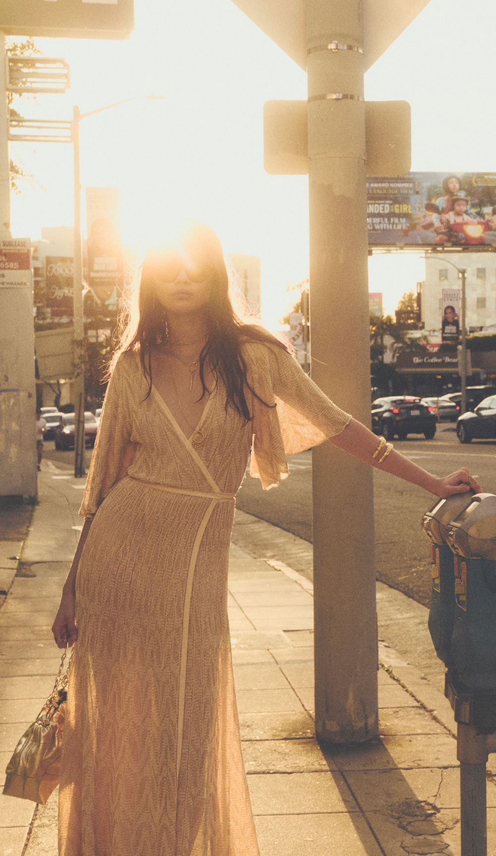 A model walking down the street in a long dress