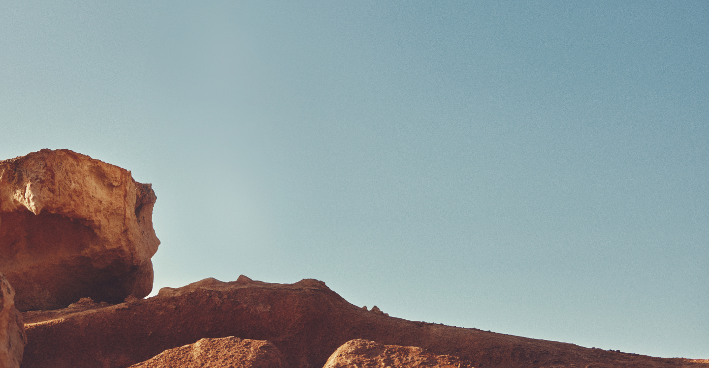 Landscape with rocks and sky: Transforming ourselves profoundly, little by little, until we become a B-certified company. With the certified B-corp logo.