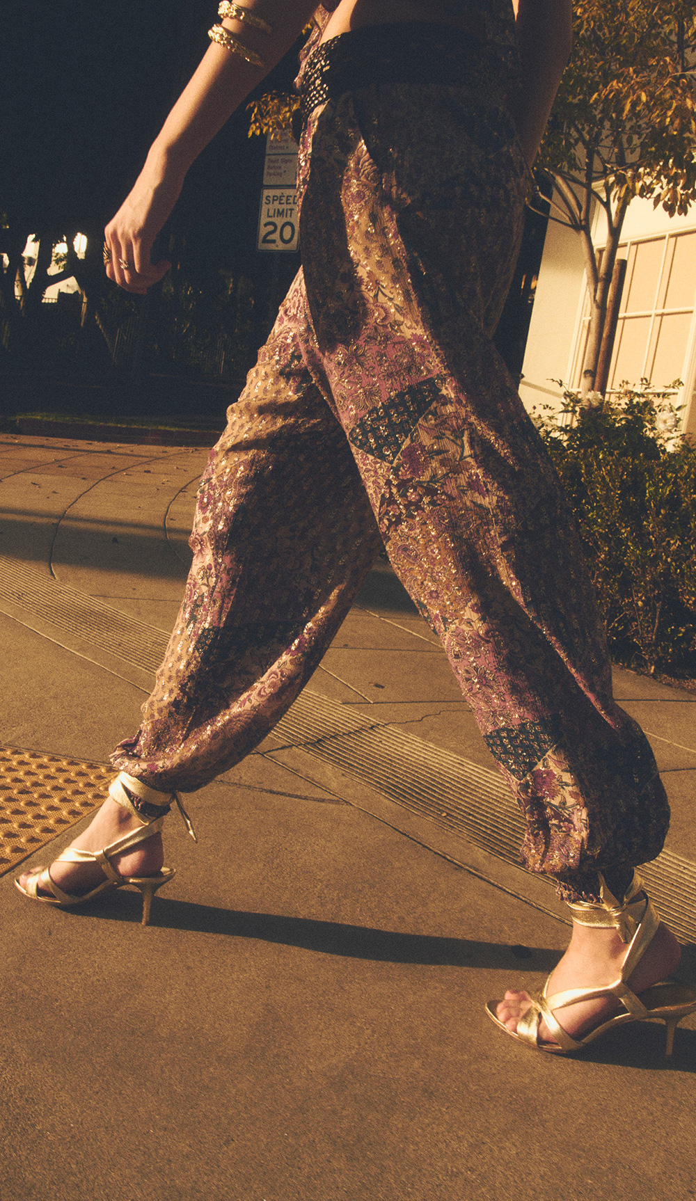 A model walking down the street in a patterned outfit