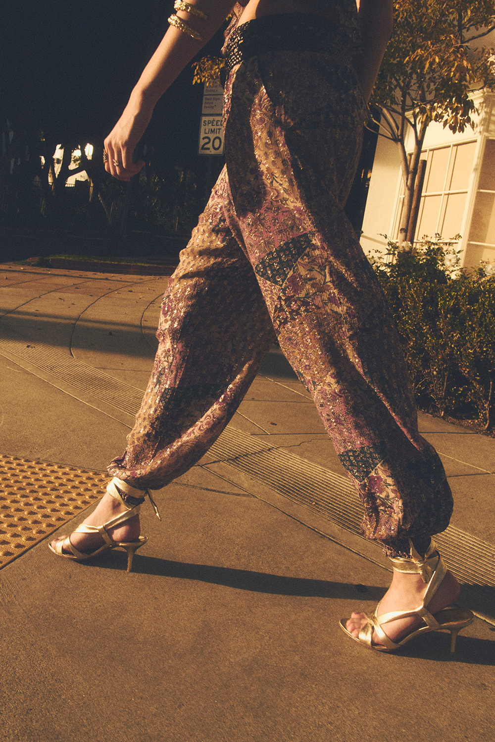 A model walking down the street in a patterned outfit